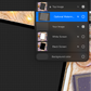 Digital tablet with layers panel open on a checkered fabric background