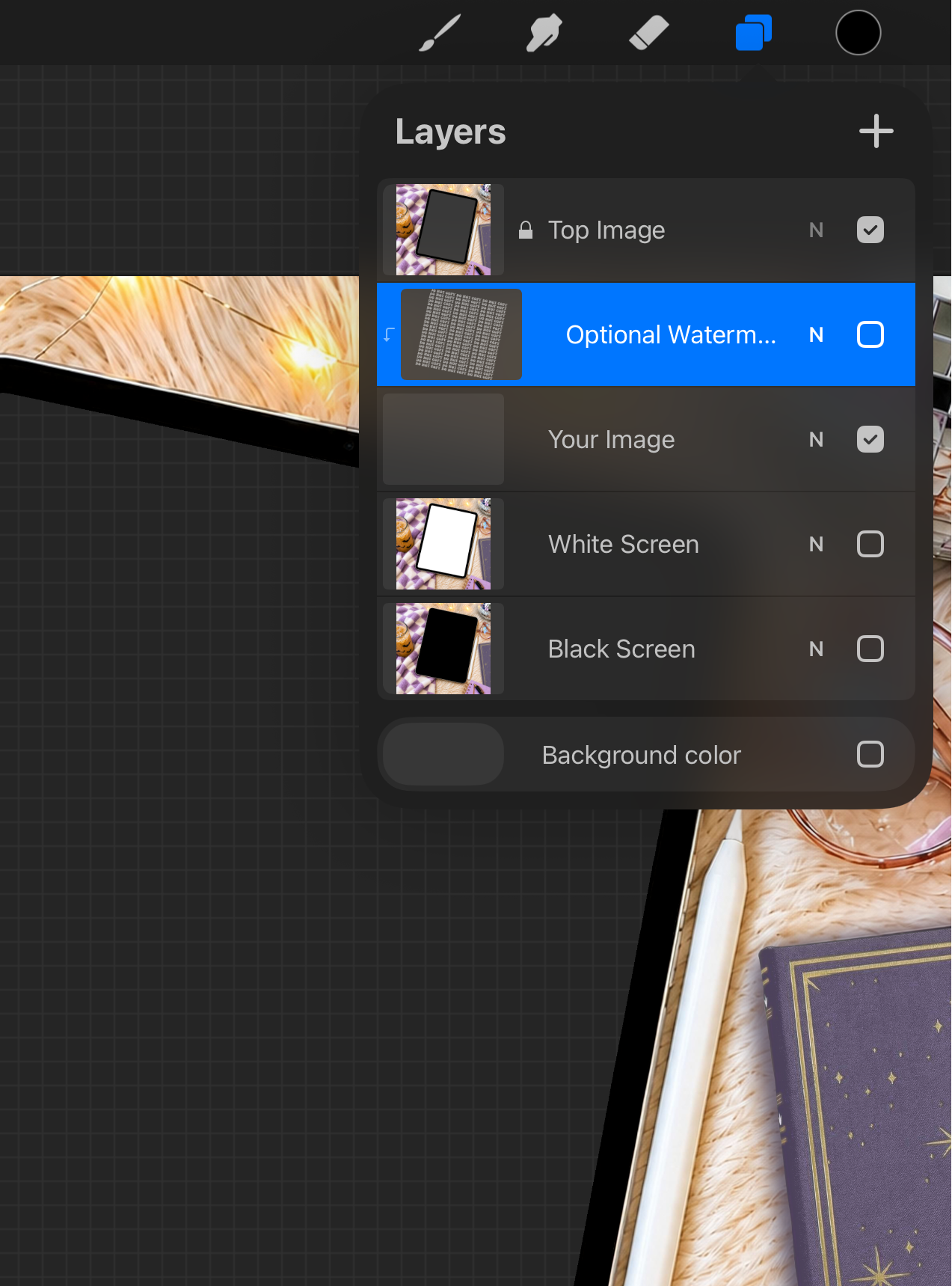 Digital tablet with layers panel open on a checkered fabric background